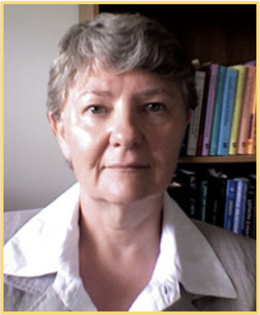 Head shot photograph of Diane Jacobs, developer of DermoNeuroModulation, standing in front of a bookshelf.